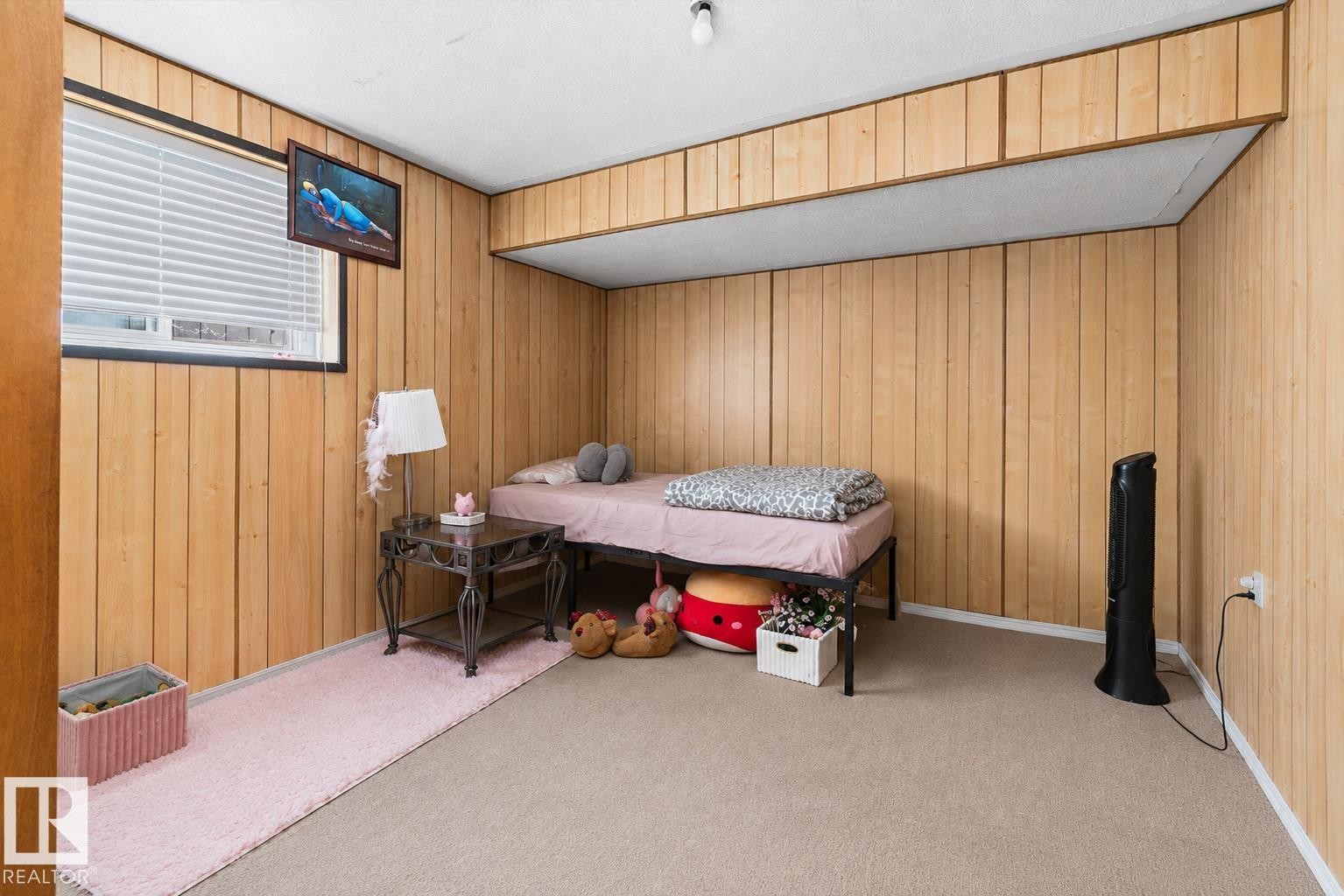 Interior room featuring wood-panel walls and light-colored carpeting - 14707 33 Street, Edmonton, AB