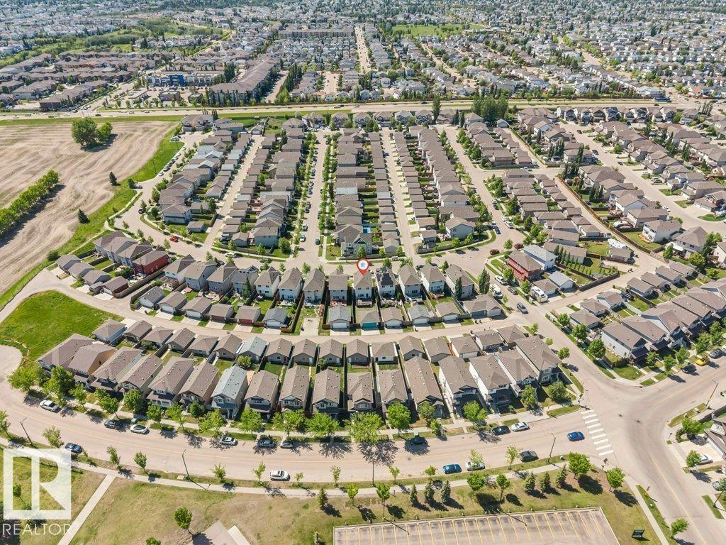 Aerial perspective of a developed residential neighborhood featuring a grid-patterned layout, curvilinear streets, and numerous detached homes - 3511 15A Street, Edmonton, AB