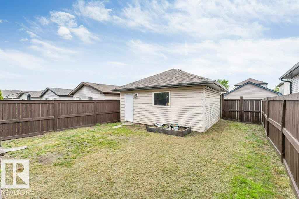 Detached outbuilding with light-colored siding and a dark shingle roof - 3511 15A Street, Edmonton, AB