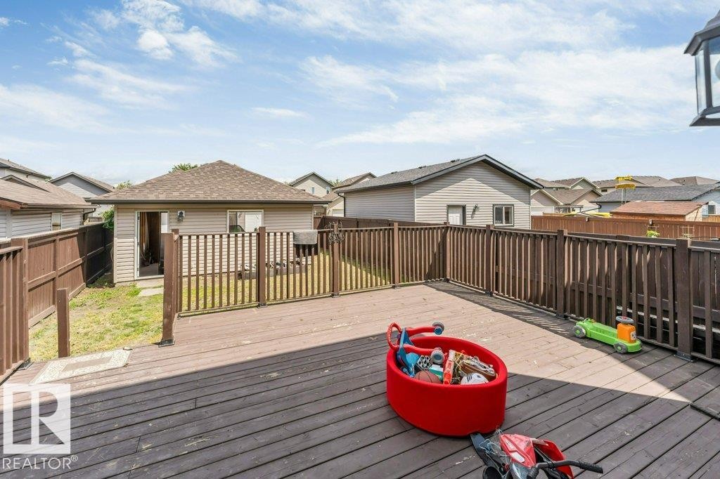 Spacious wood-finish deck with perimeter railing and integrated gate - 3511 15A Street, Edmonton, AB