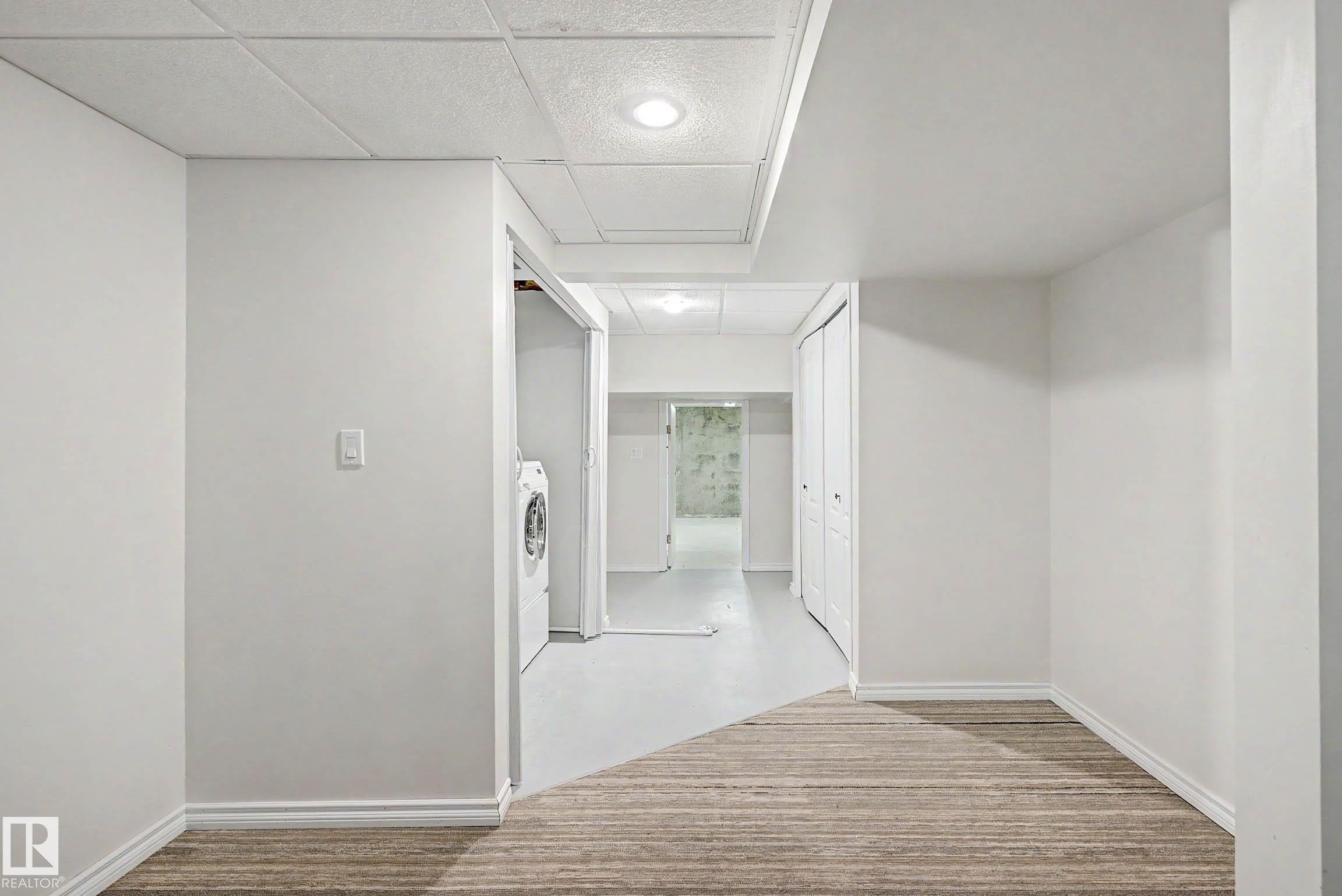 Lower level featuring neutral wall tones and a combination of carpet and light-toned flooring - 3718 103B Street Nw, Edmonton, AB - Indoor Photo Showing Other Room