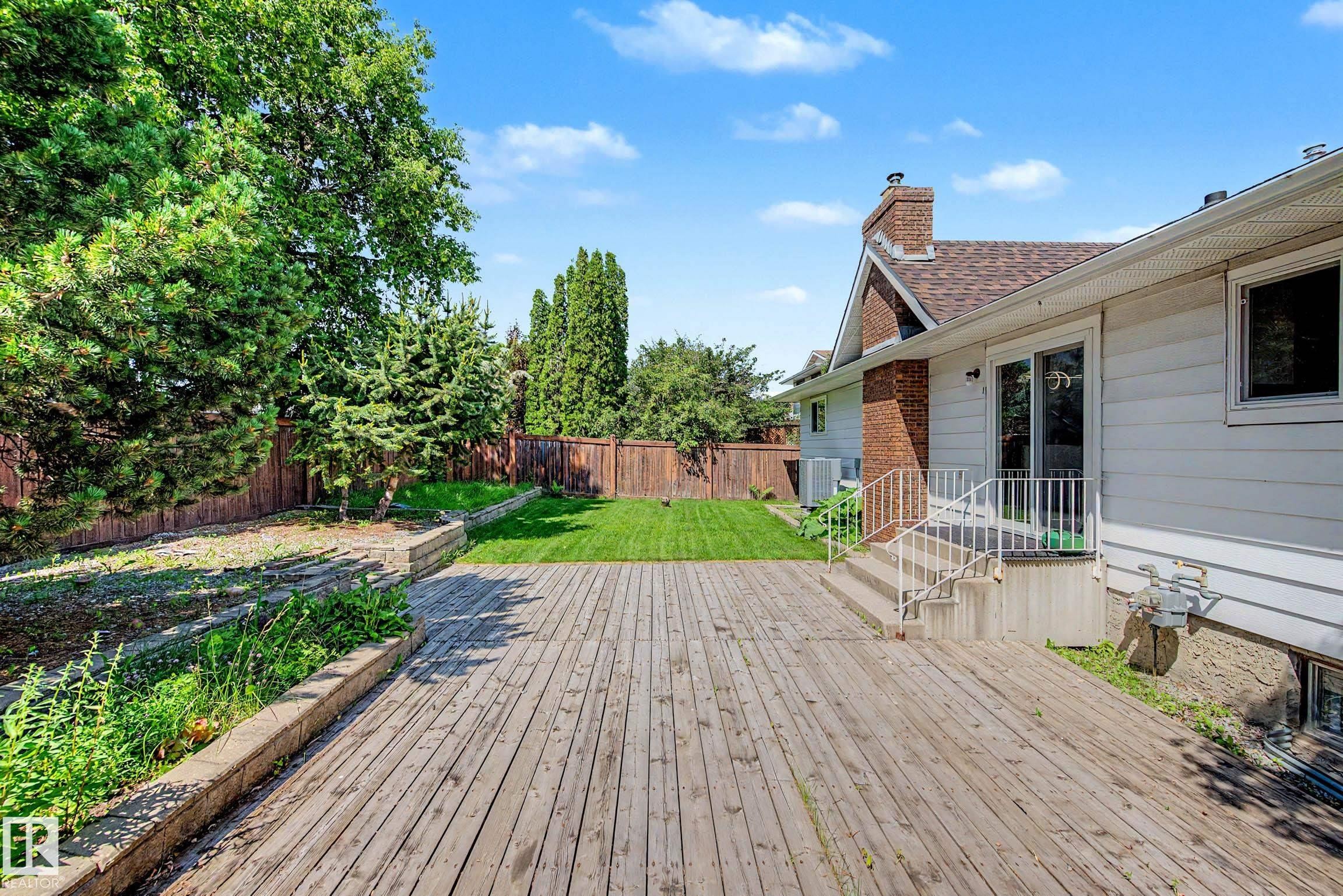 Expansive wood-finish deck spanning the rear of the property - 3718 103B Street Nw, Edmonton, AB - Outdoor With Deck Patio Veranda