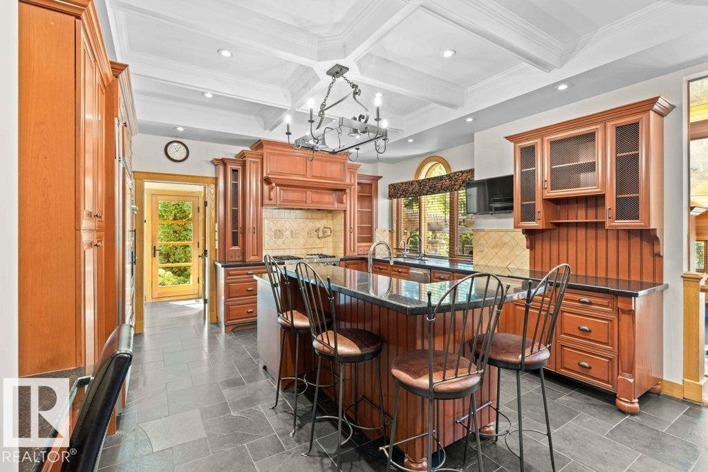 Custom Cherry wood kitchen cabinets with island and two sinks. - 738 Wheeler Road, Edmonton, AB