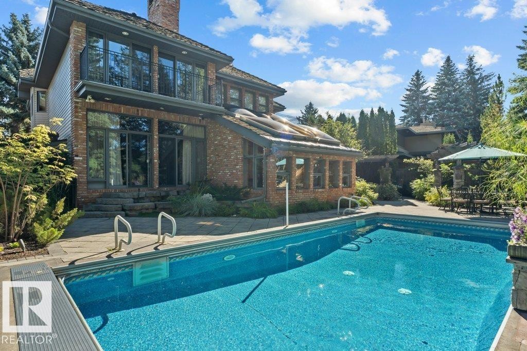 Back of property with two balconies, complete stone patio and pool. - 738 Wheeler Road, Edmonton, AB