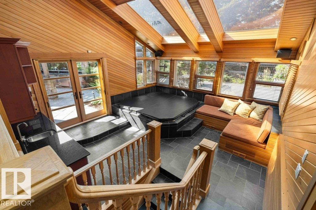 With skylight, custom millwork with granite countertops, cherry wood cabinetry, slate flooring and French doors. - 738 Wheeler Road, Edmonton, AB