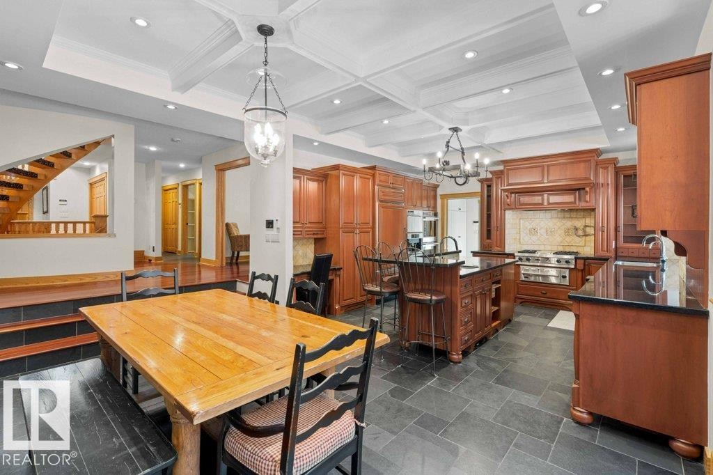 Kitchen with granite countertops, custom tile backsplash, Miele, Subzero and KitchenAid appliances featuring trash compactor, dual wall ovens plus garburator - 738 Wheeler Road, Edmonton, AB