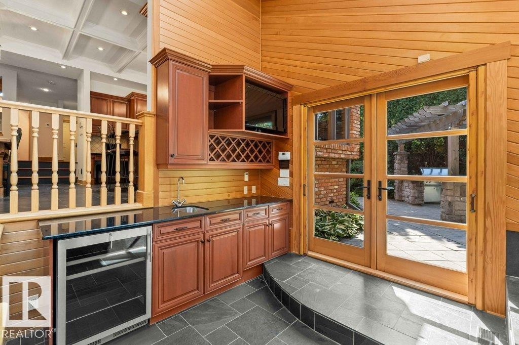With skylight, custom millwork with granite countertops, cherry wood cabinetry, slate flooring and French doors. Liebherr refrigerator. - 738 Wheeler Road, Edmonton, AB