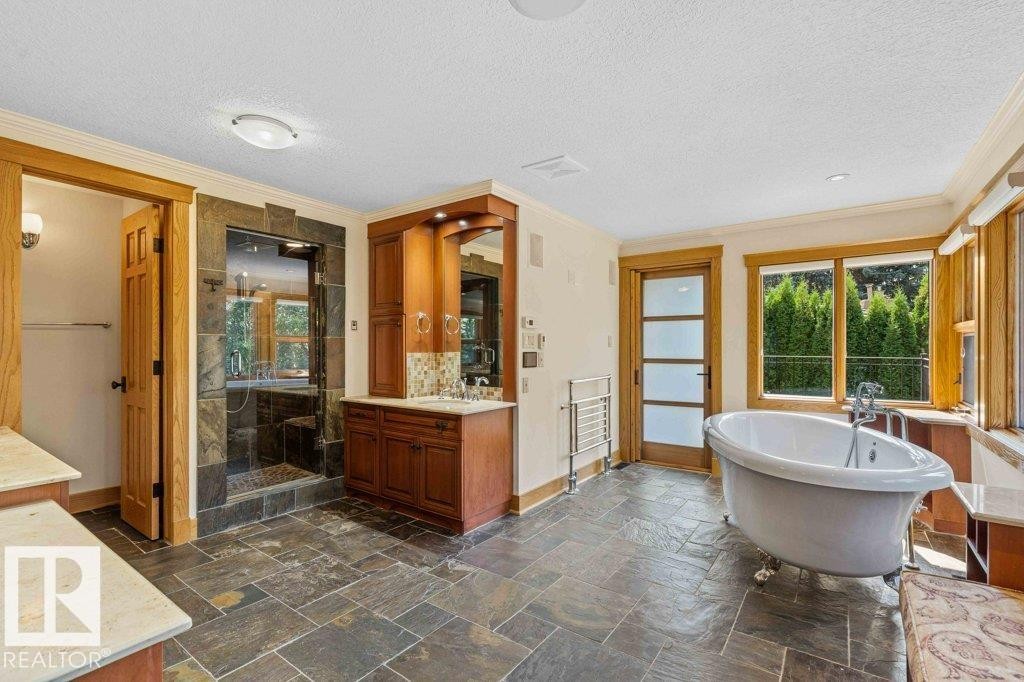 Master ensuite with heated slate flooring, steam shower, Grohe taps throughout, hydronic heated towel bar and air jetted tub. - 738 Wheeler Road, Edmonton, AB
