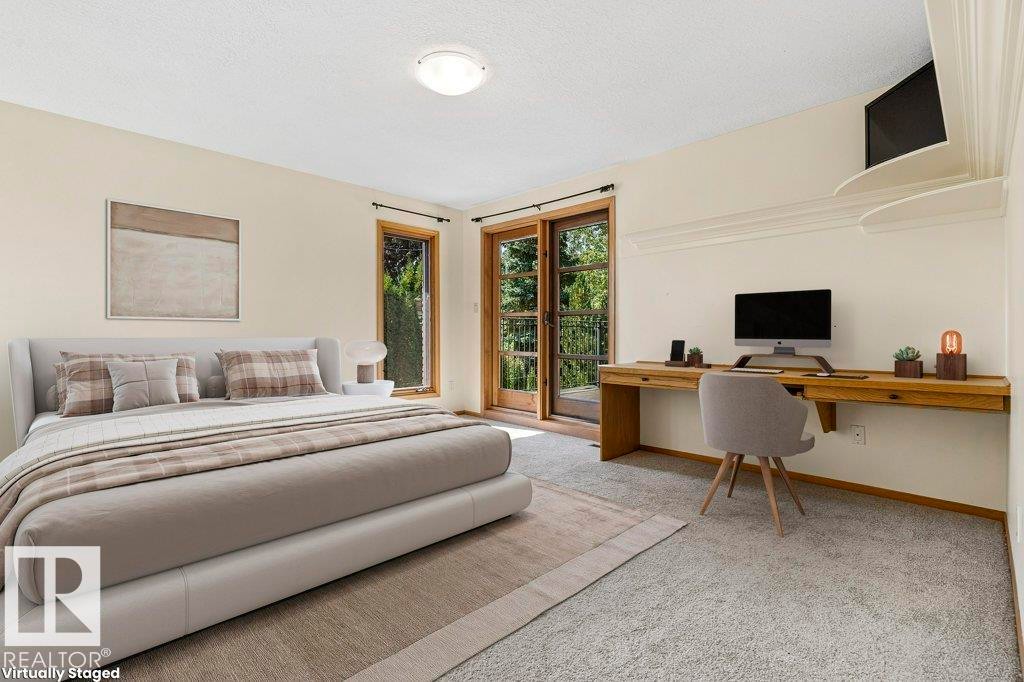 Carpeted bedroom with access to exterior, a textured ceiling, and built in study area - 738 Wheeler Road, Edmonton, AB