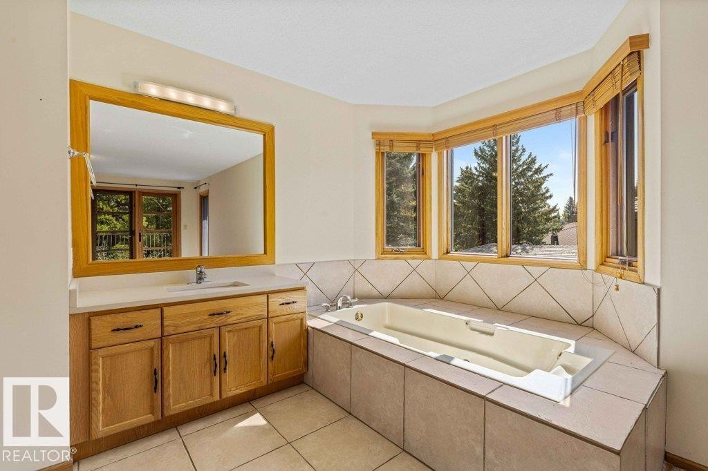 Full bathroom with vanity, a bath, and light tile patterned floors - 738 Wheeler Road, Edmonton, AB