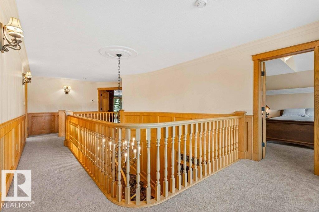 Upper foyer with oak railing and wainscoting plus new carpet. - 738 Wheeler Road, Edmonton, AB
