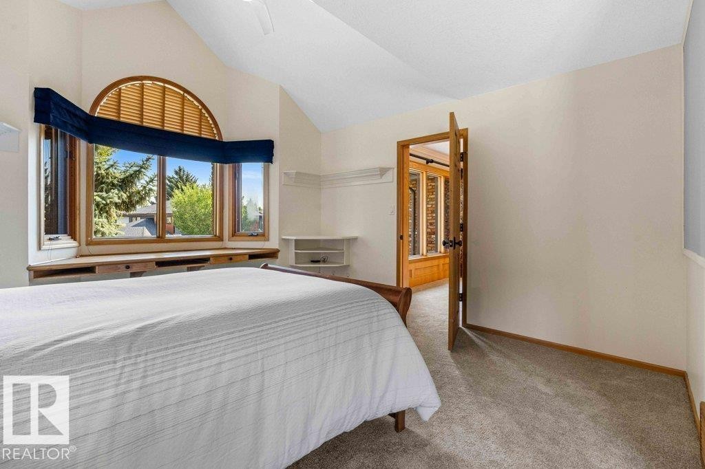 Carpeted bedroom featuring baseboards and high vaulted ceiling - 738 Wheeler Road, Edmonton, AB