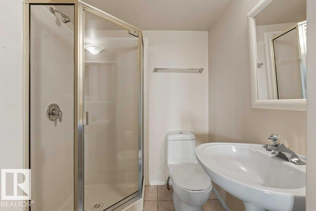 Bathroom featuring tile patterned floors and a shower stall - 738 Wheeler Road, Edmonton, AB