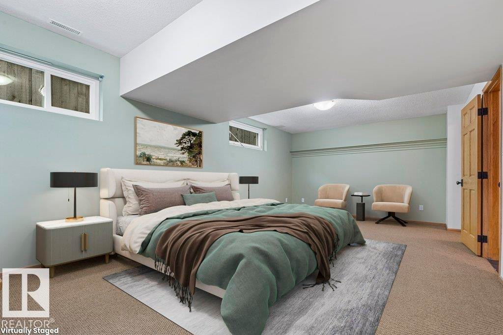 Carpeted bedroom featuring a textured ceiling - 738 Wheeler Road, Edmonton, AB