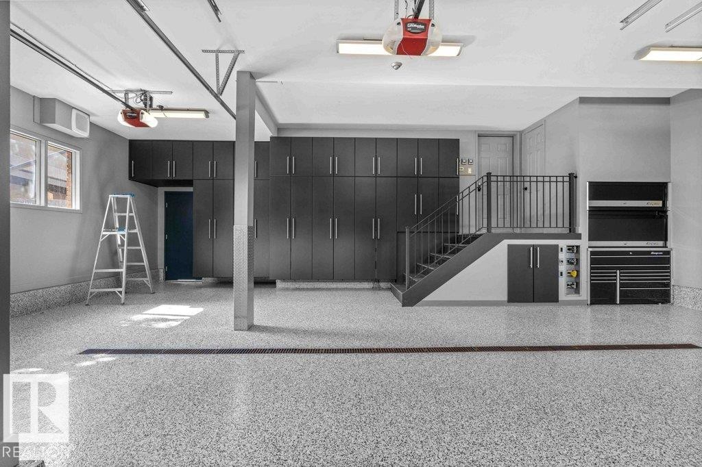Garage featuring epoxy floor with drain, heated floors, custom millwork and Snap On tool chest. - 738 Wheeler Road, Edmonton, AB