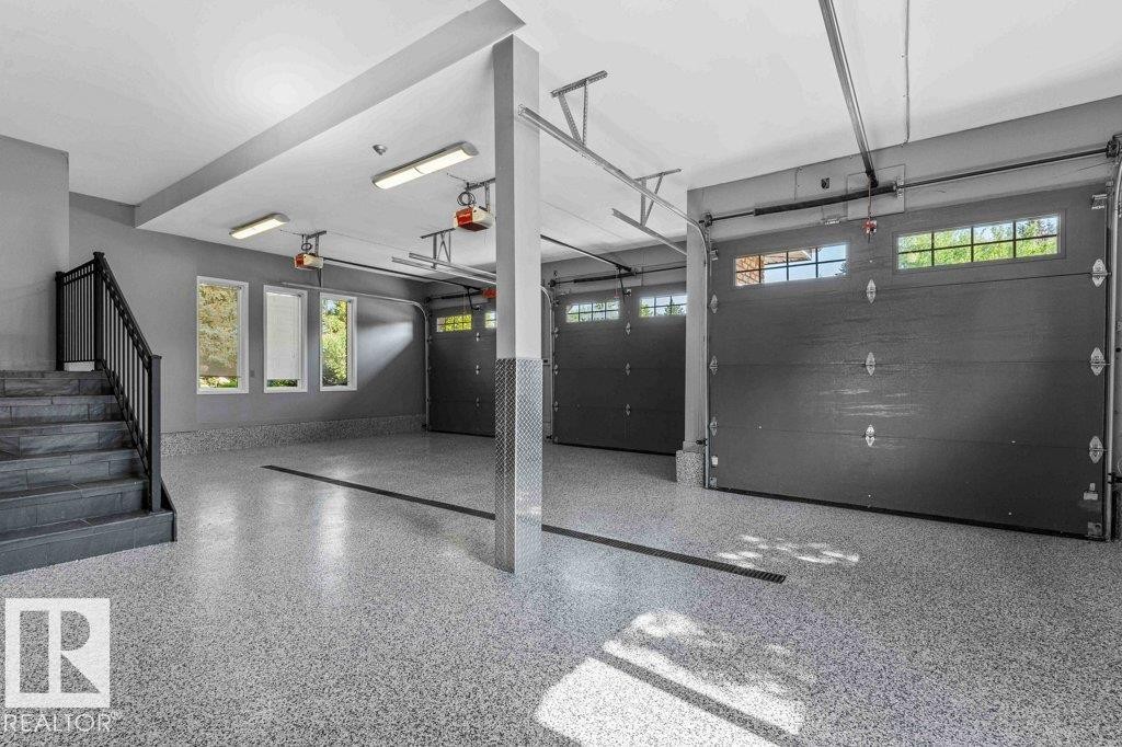 Garage featuring epoxy floor with drain, heated floors, custom millwork and Snap On tool chest. - 738 Wheeler Road, Edmonton, AB