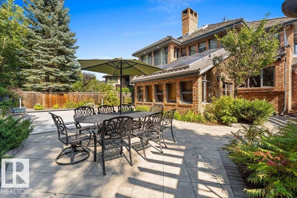 Outdoor living with pergola with two gas radiant heaters, gas light fireplace, patio stone flooring and pizza oven. - 738 Wheeler Road, Edmonton, AB