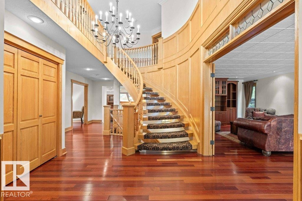 Grand entrance featuring curved oak staircase, wool carpeting, chandelier, French doors and Brazilian cherry flooring. - 738 Wheeler Road, Edmonton, AB
