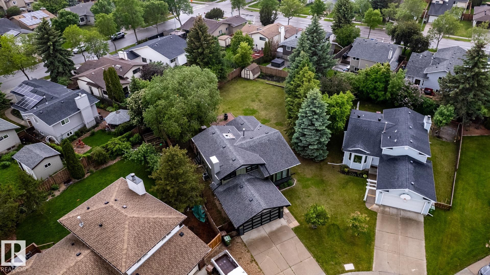 Single-family residence featuring a dark shingle roof, attached garage, and light-toned siding - 27 Danforth Crescent, St. Albert, AB