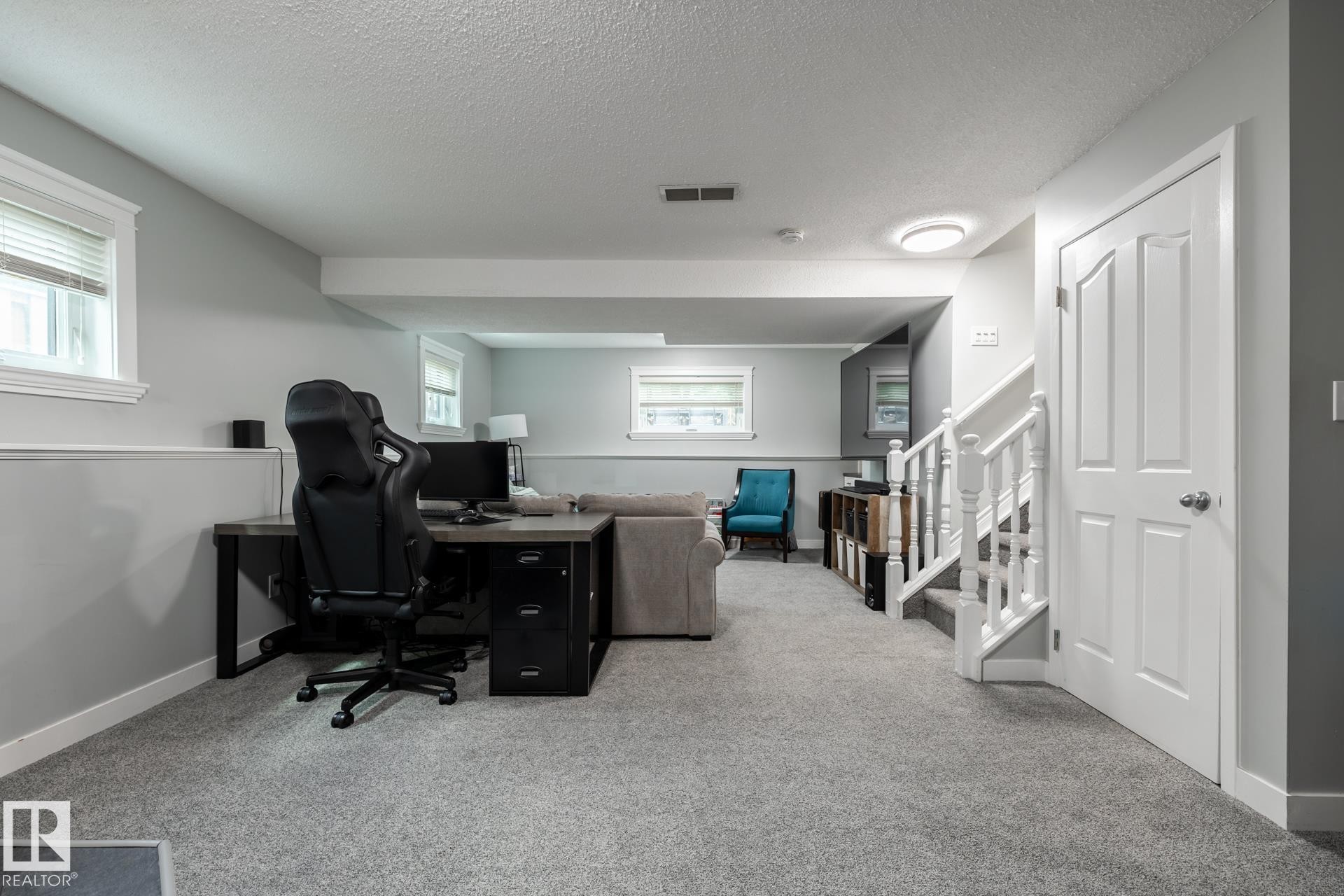 Finished lower level with soft gray carpeting and light gray walls - 27 Danforth Crescent, St. Albert, AB