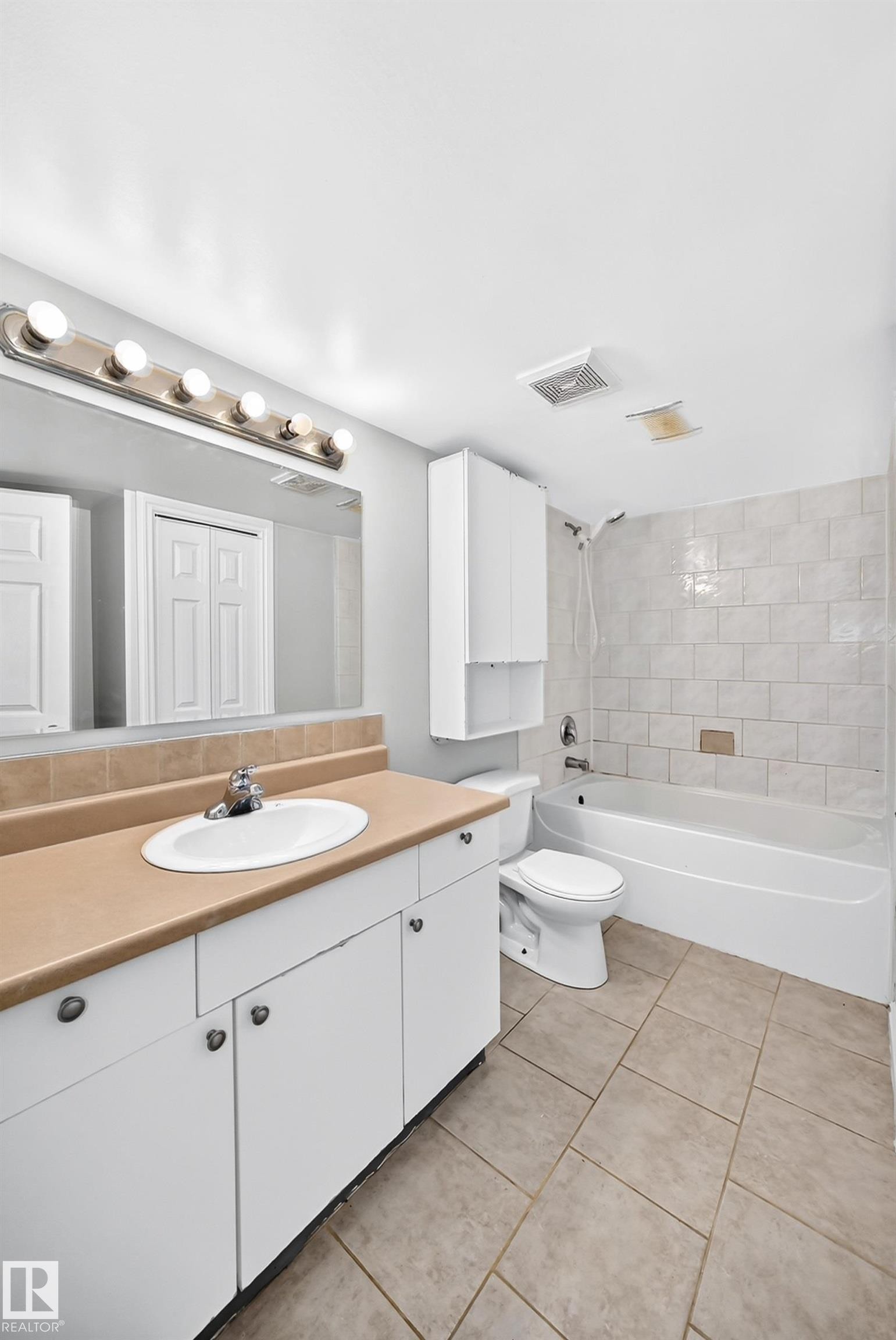 White vanity with an integrated sink, laminate countertop, and brushed nickel hardware - 1103 56 Street, Edmonton, AB