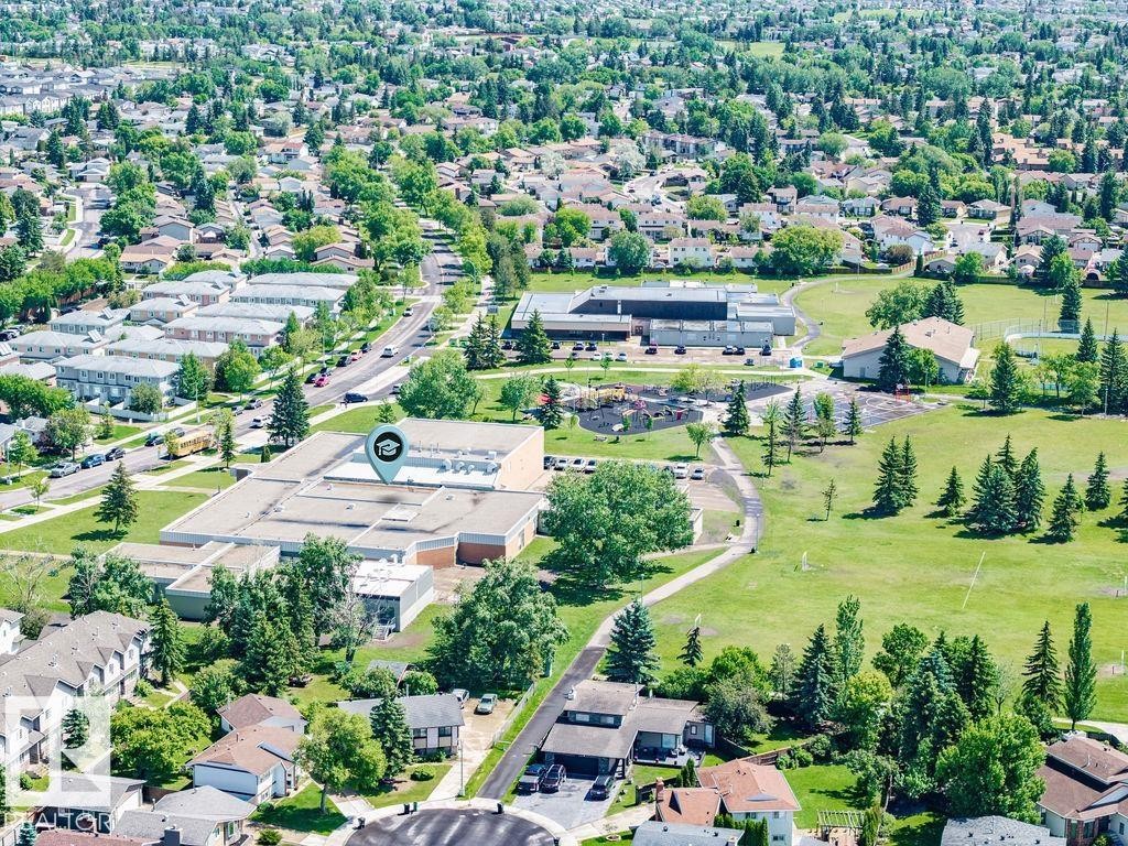 Expansive aerial perspective showcasing a residential area with extensive green spaces and mature trees - 17009 109 Street, Edmonton, AB
