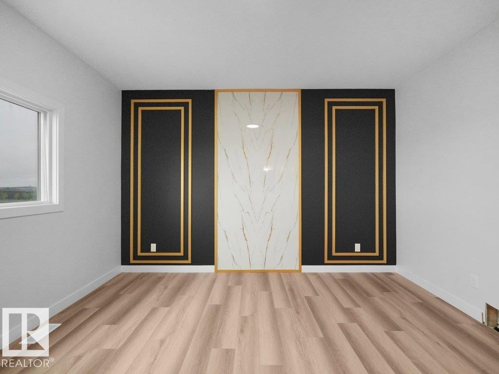 Accent wall featuring a central marble-effect panel framed by black panels with gold trim - 18719 130 Street Nw, Edmonton, AB