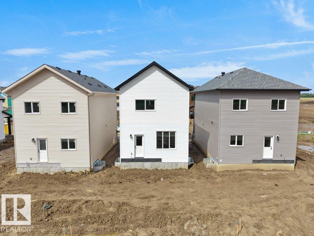Newly constructed residential properties featuring durable siding exteriors and asphalt shingle roofing - 18719 130 Street Nw, Edmonton, AB
