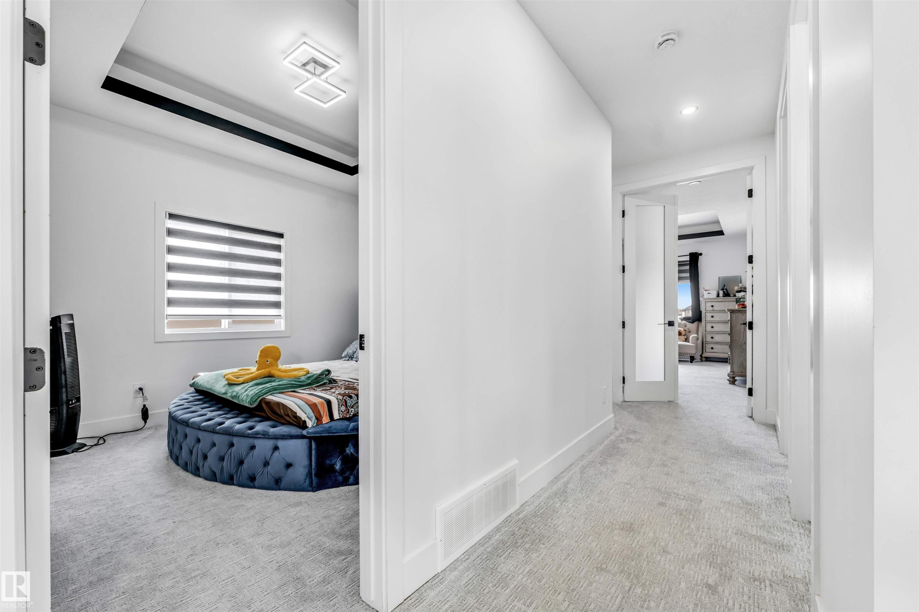 Hallway featuring light-toned carpeting and white baseboards - 208 33 Street, Edmonton, AB