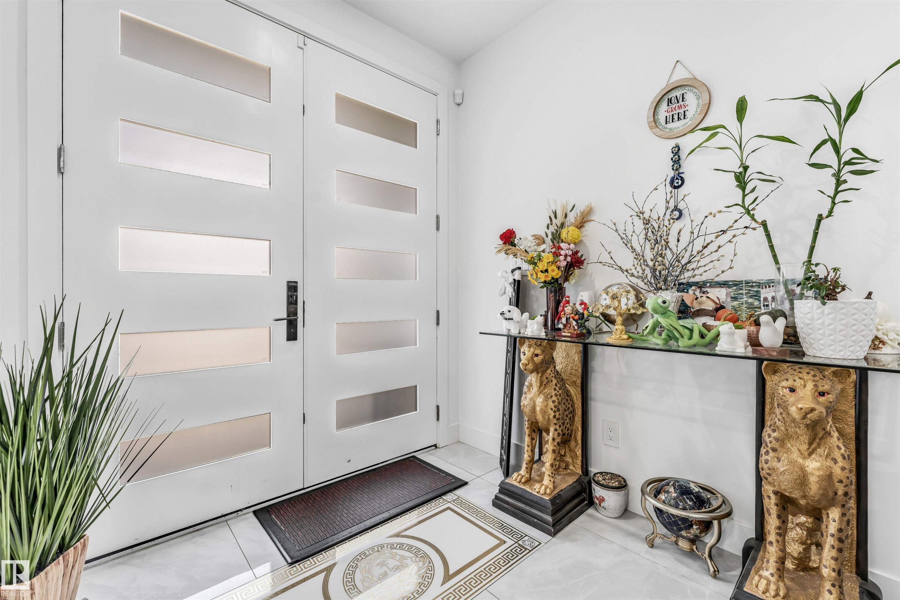 Double entry doors with frosted glass panels, black hardware, and polished tile flooring - 208 33 Street, Edmonton, AB