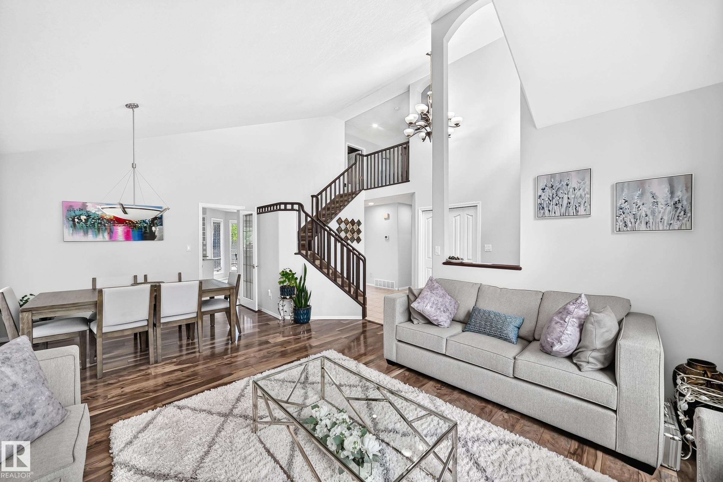 Vaulted ceilings enhance this open-concept interior featuring wood-finish flooring - 4216 47 Street, Edmonton, AB