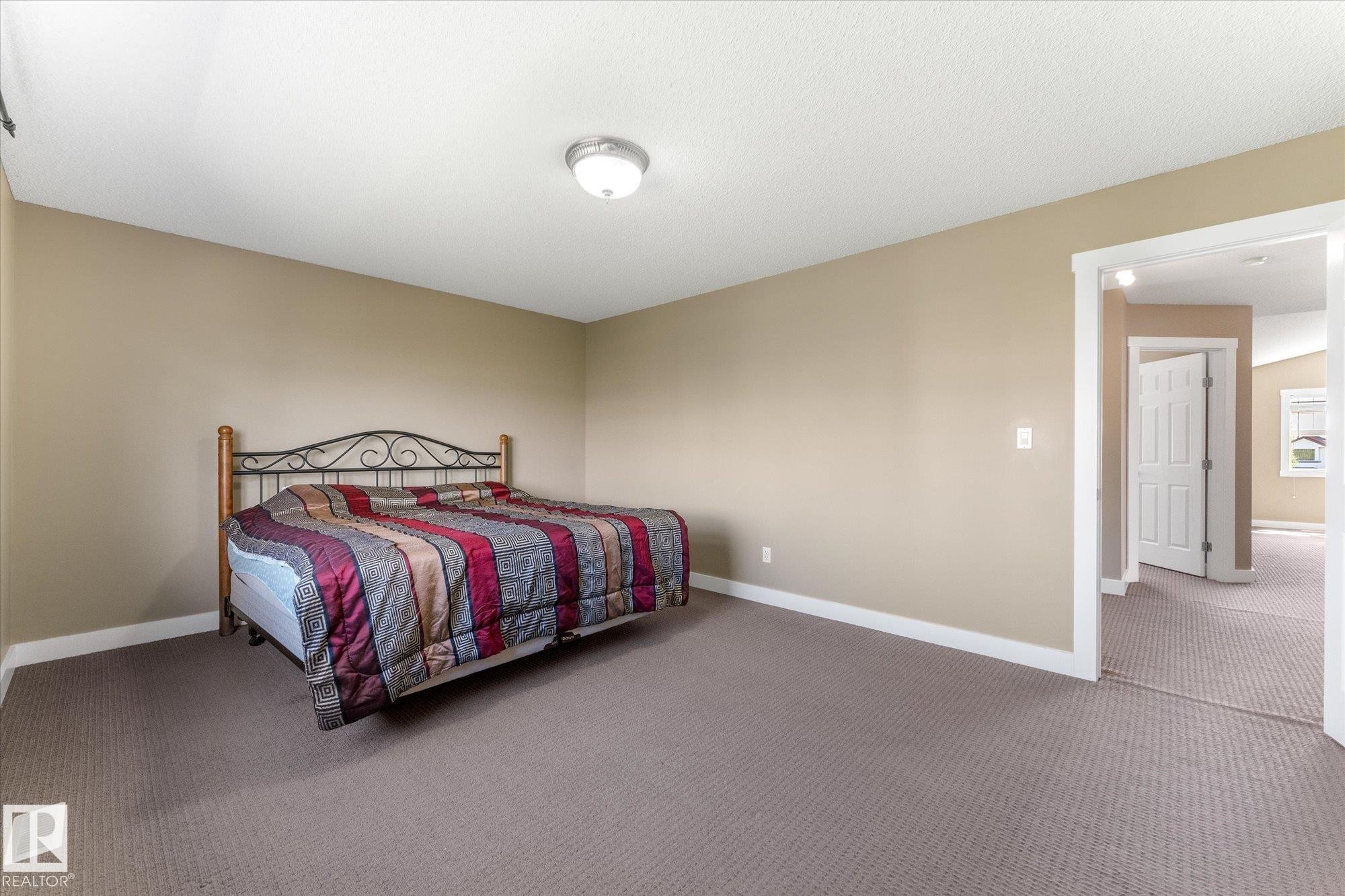 Spacious room featuring neutral-toned walls, recessed ceiling lighting, and wall-to-wall carpeting - 488 Macewan Road, Edmonton, AB
