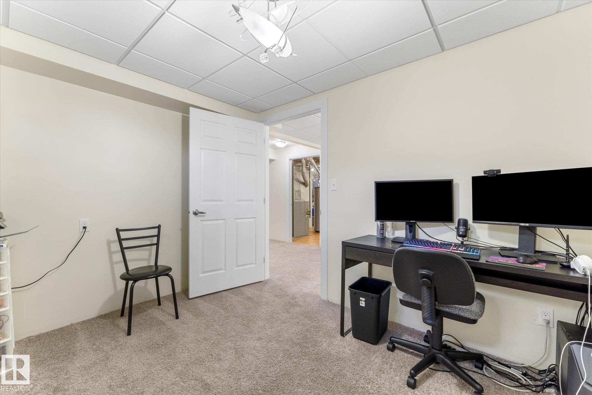 Carpeted room featuring a drop ceiling with recessed lighting - 488 Macewan Road, Edmonton, AB
