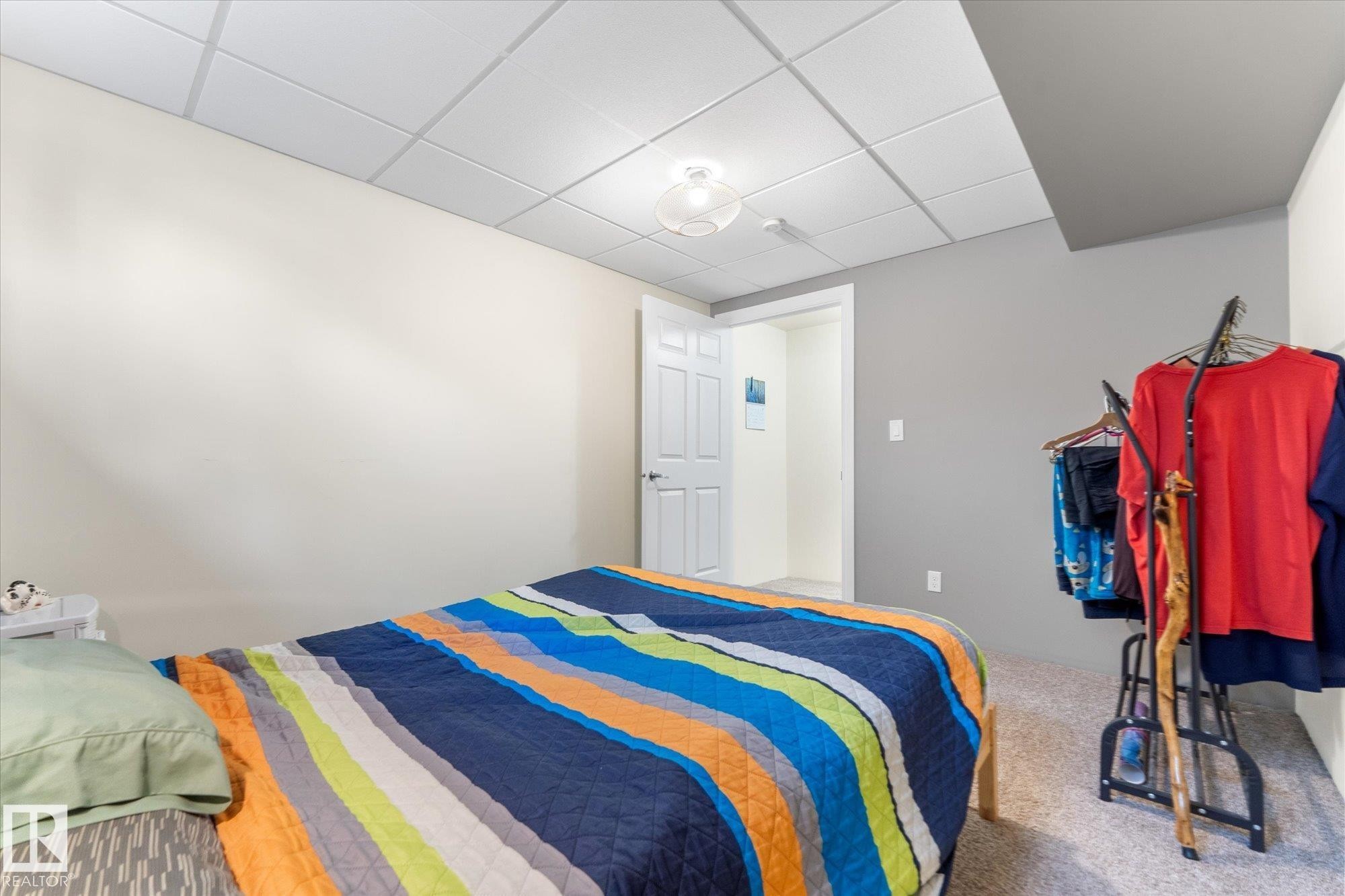 Carpeted room featuring a drop ceiling with recessed lighting - 488 Macewan Road, Edmonton, AB
