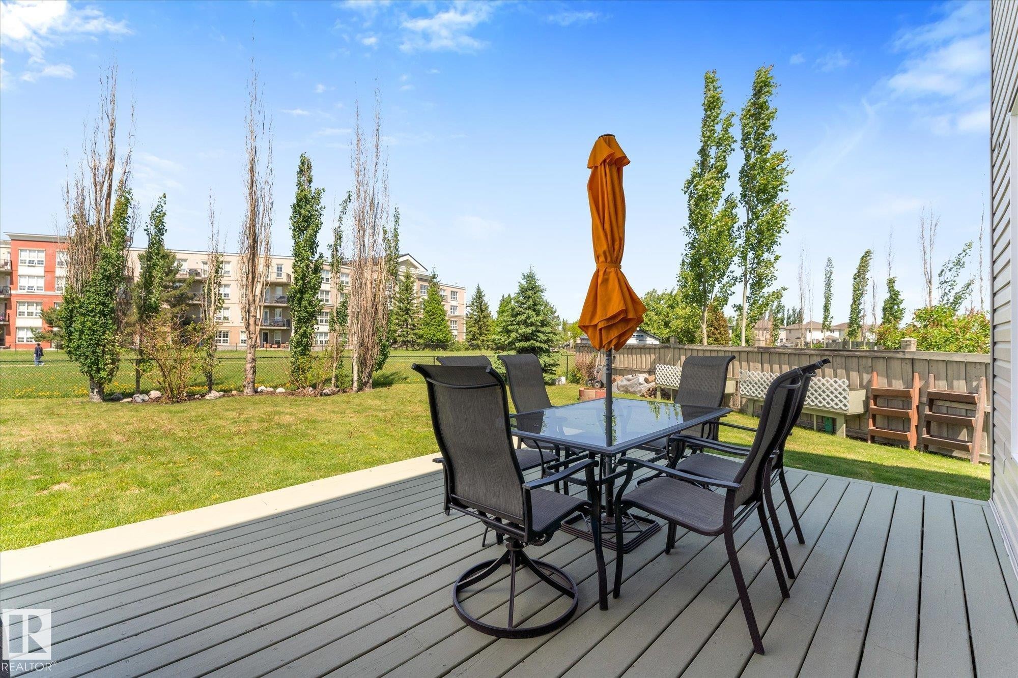 Spacious outdoor deck with composite decking and a privacy wall - 488 Macewan Road, Edmonton, AB