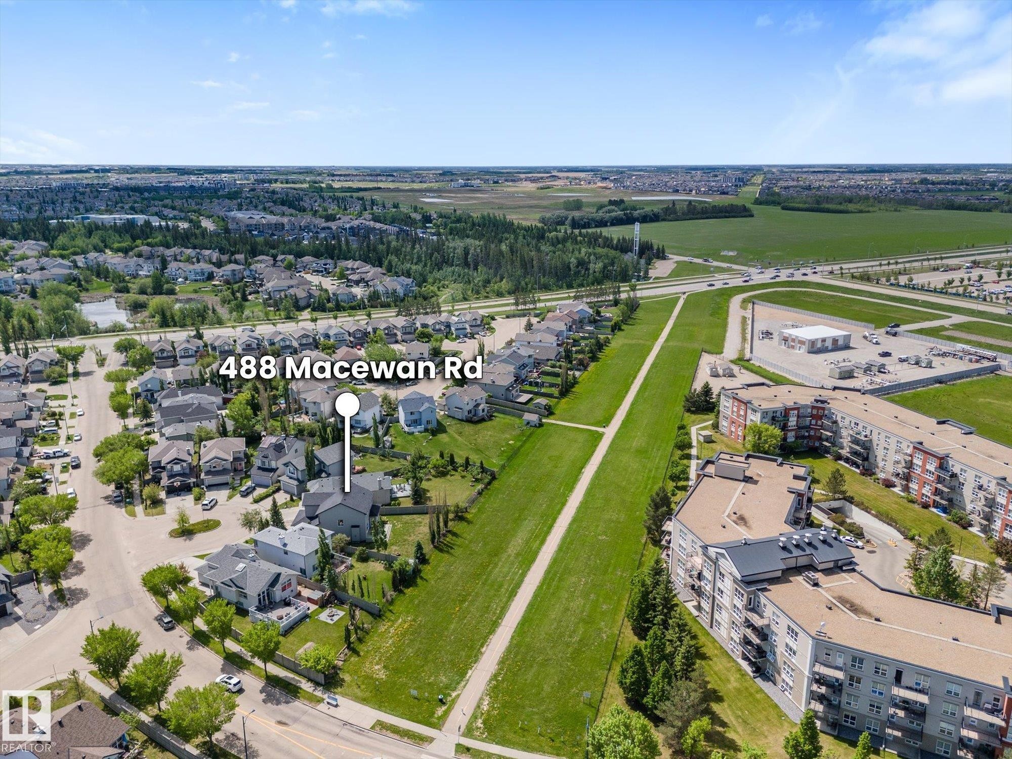 Aerial perspective of a suburban neighborhood featuring single-family homes and multi-story residential buildings - 488 Macewan Road, Edmonton, AB