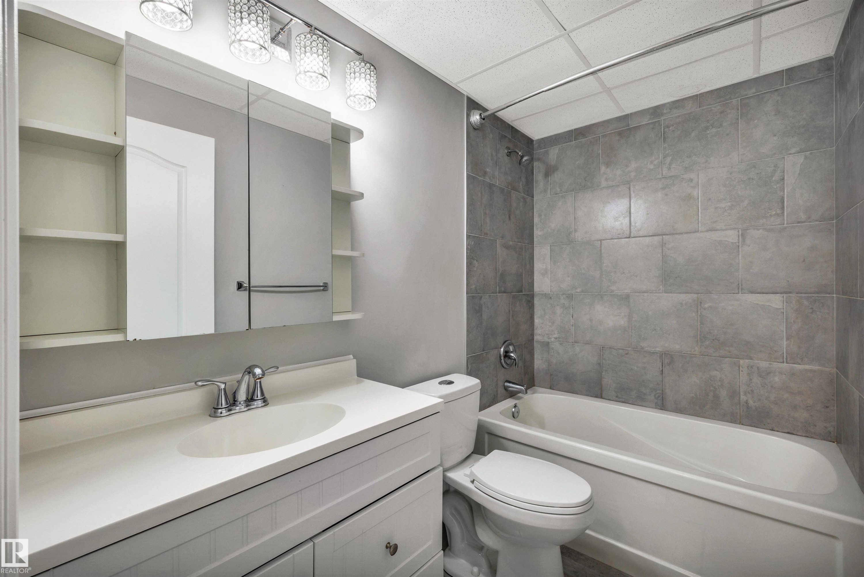 Full bathroom featuring a vanity with integrated sink, chrome faucet, and cabinet storage - 18 Voleta Crest, Spruce Grove, AB
