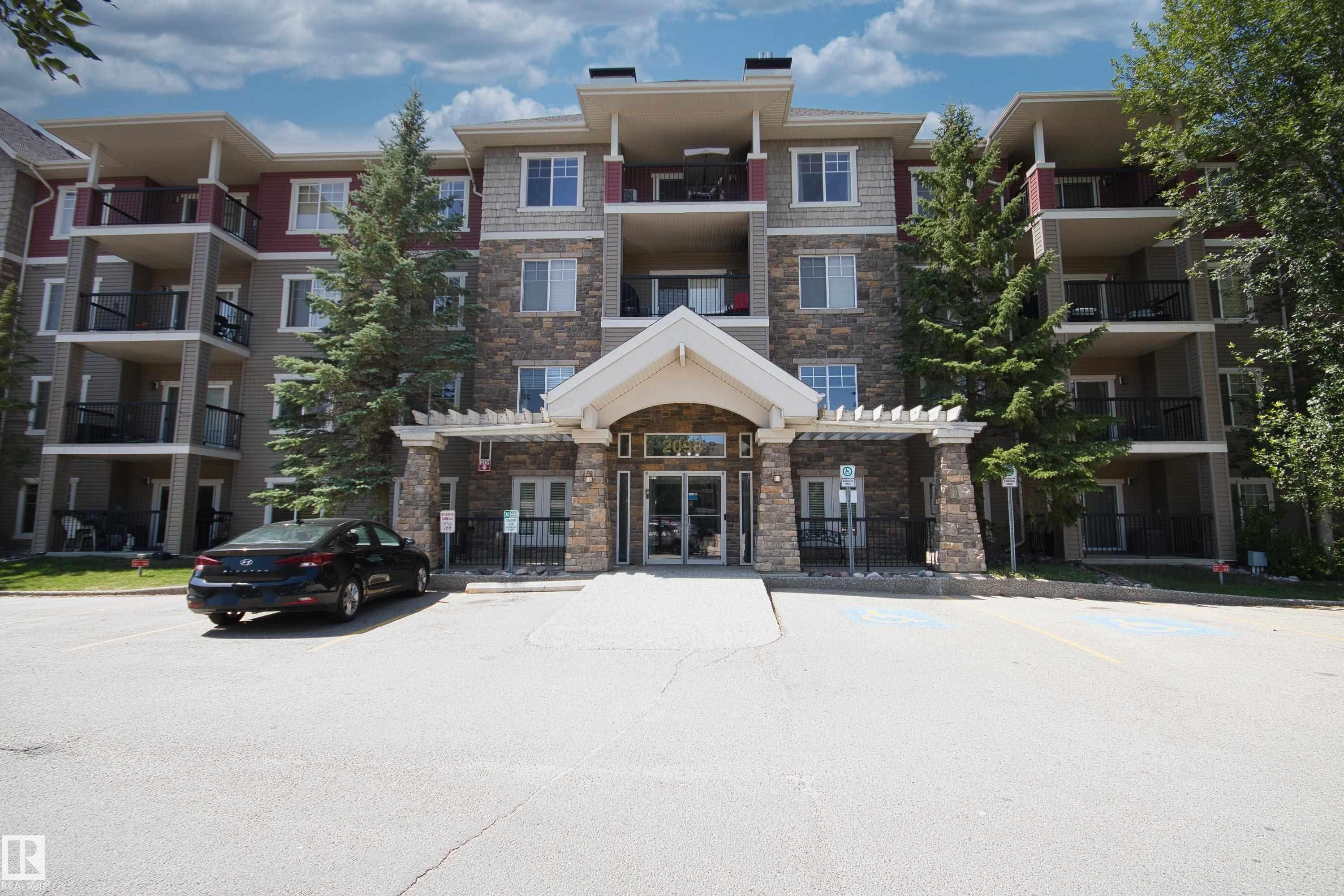 View of apartment building / complex featuring uncovered parking - 311 2098 Blackmud Creek Drive, Edmonton, AB