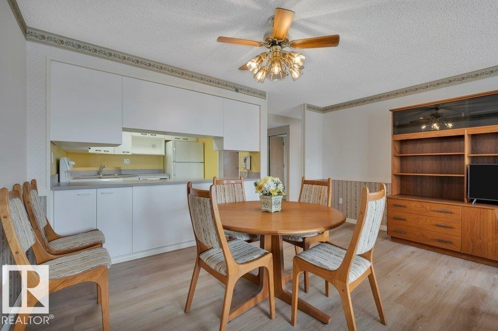 Open-concept living space featuring a wood-finish dining table and coordinated chairs - 316 2011 137 Avenue, Edmonton, AB - Indoor Photo Showing Dining Room