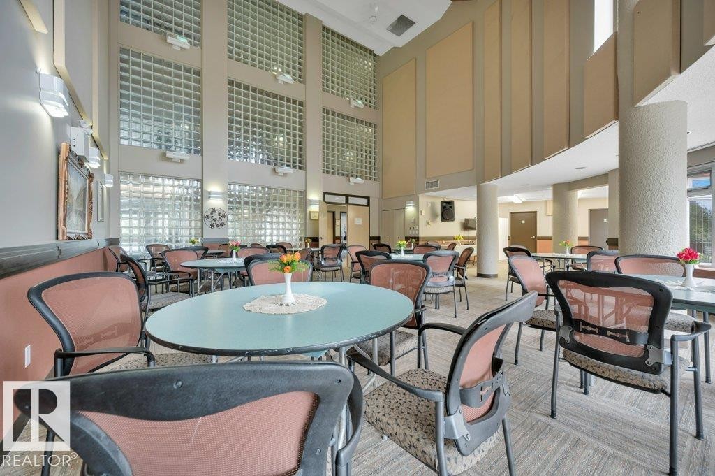 Multi-level interior space featuring extensive glass block windows, high ceilings, and a combination of recessed and wall-mounted lighting - 316 2011 137 Avenue, Edmonton, AB - Indoor