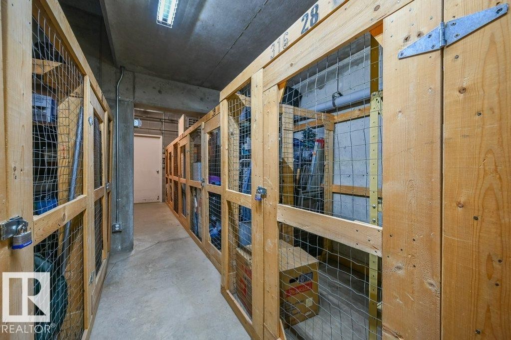 Storage corridor featuring individual wood-framed storage units with wire mesh panels - 316 2011 137 Avenue, Edmonton, AB - Indoor Photo Showing Other Room