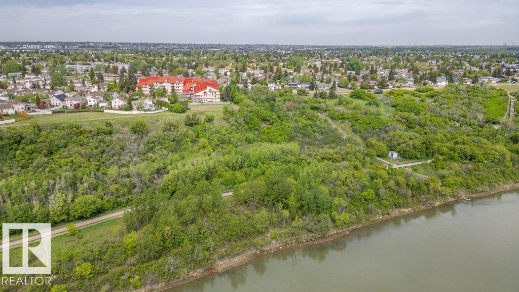 Expansive waterside property featuring dense mature trees and verdant landscaping - 316 2011 137 Avenue, Edmonton, AB - Outdoor With Body Of Water With View