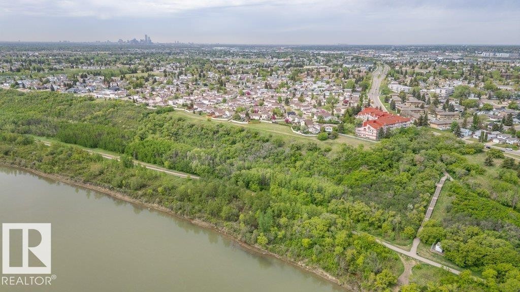 Aerial perspective showcasing a riverfront setting with established residential areas - 316 2011 137 Avenue, Edmonton, AB - Outdoor With Body Of Water With View