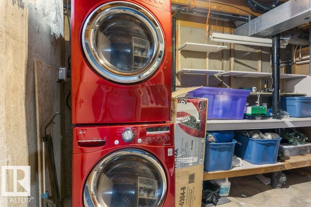 Dedicated laundry area featuring a stacked washer and dryer, adjacent to built-in shelving - 171 Ridgewood, St. Albert, AB
