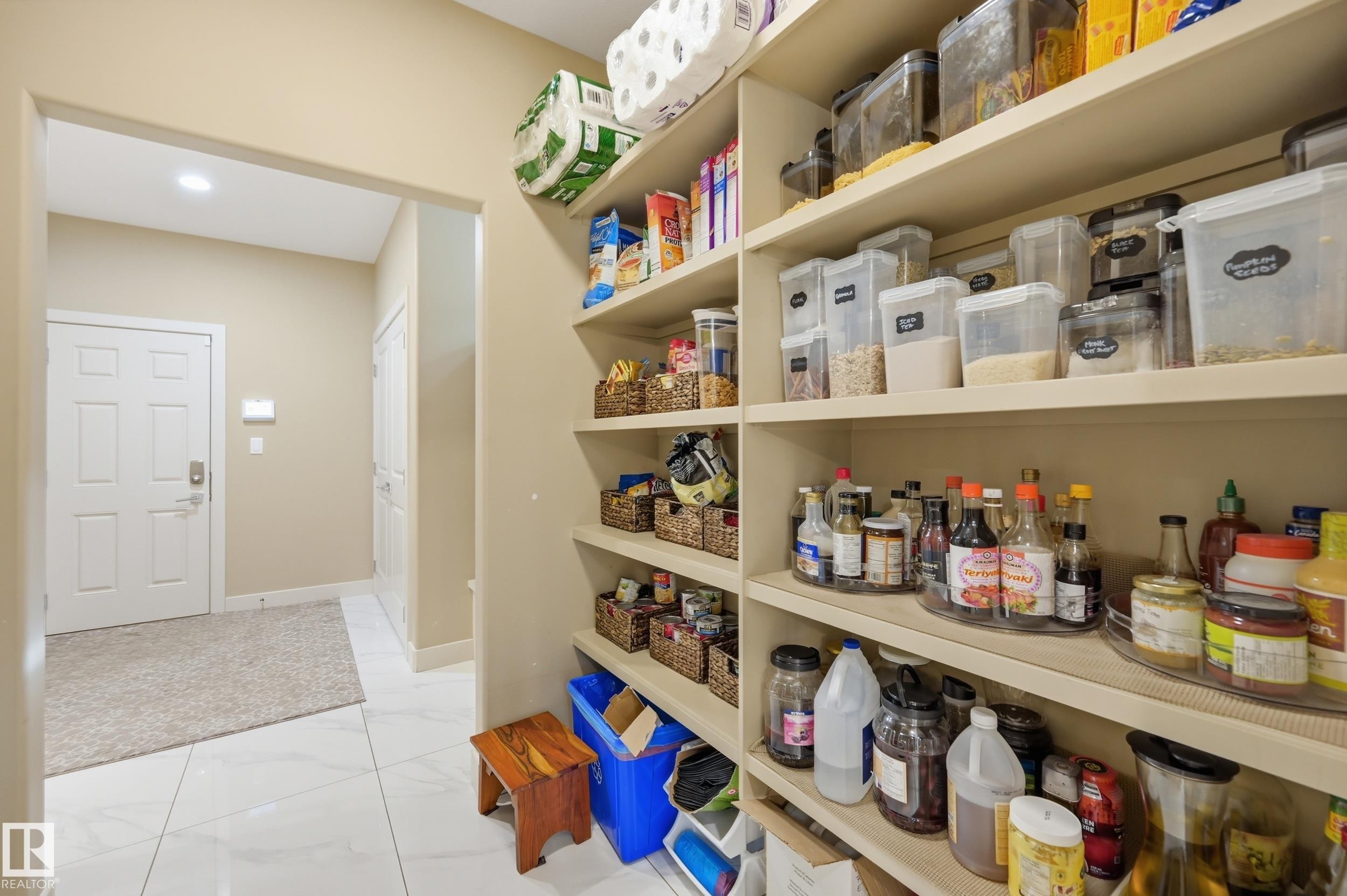 Built-in pantry shelving featuring light-toned wood-finish shelves - 76 Jacobs Close, St. Albert, AB