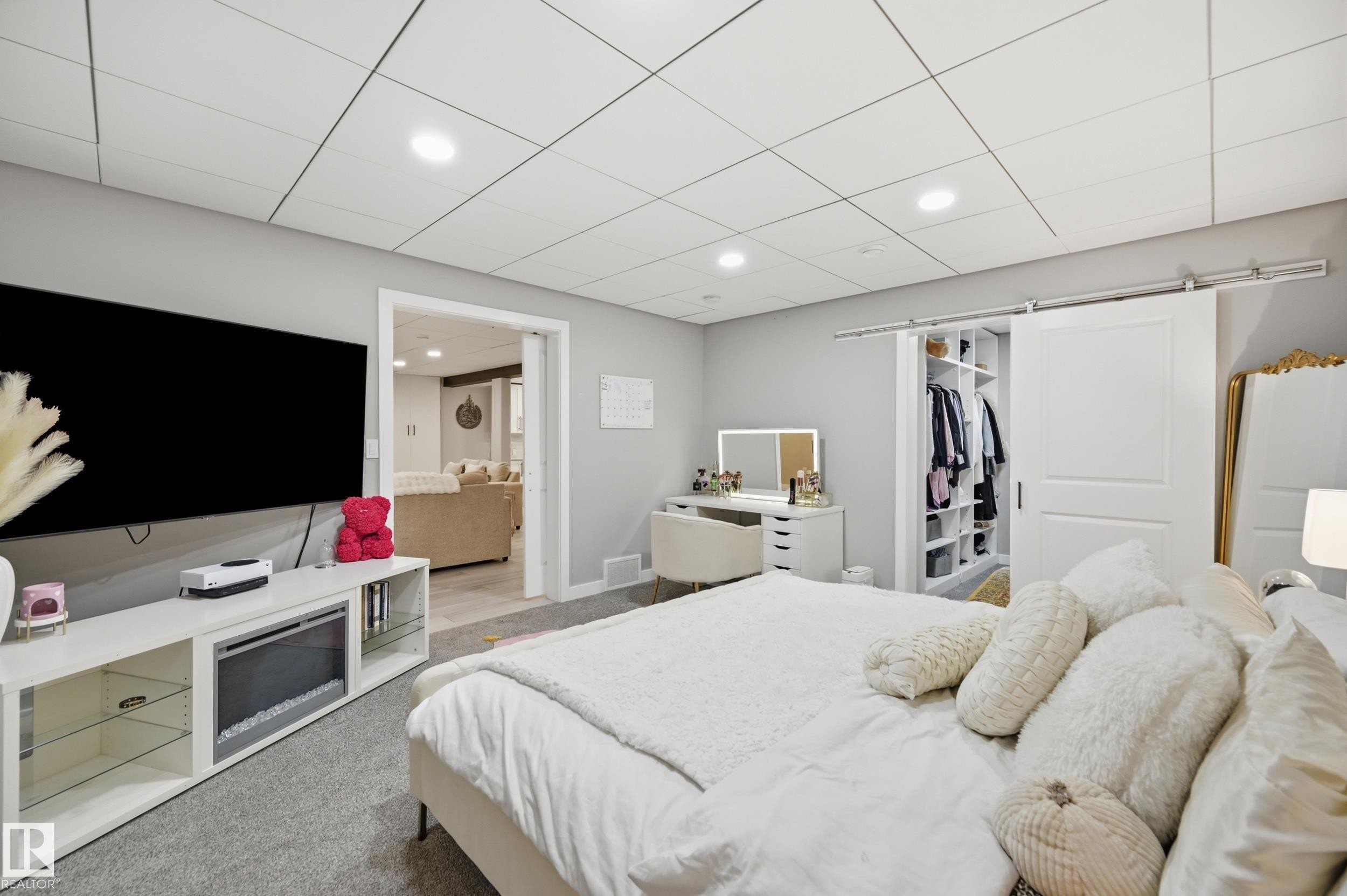 Bedroom featuring a built-in electric fireplace and media console - 76 Jacobs Close, St. Albert, AB