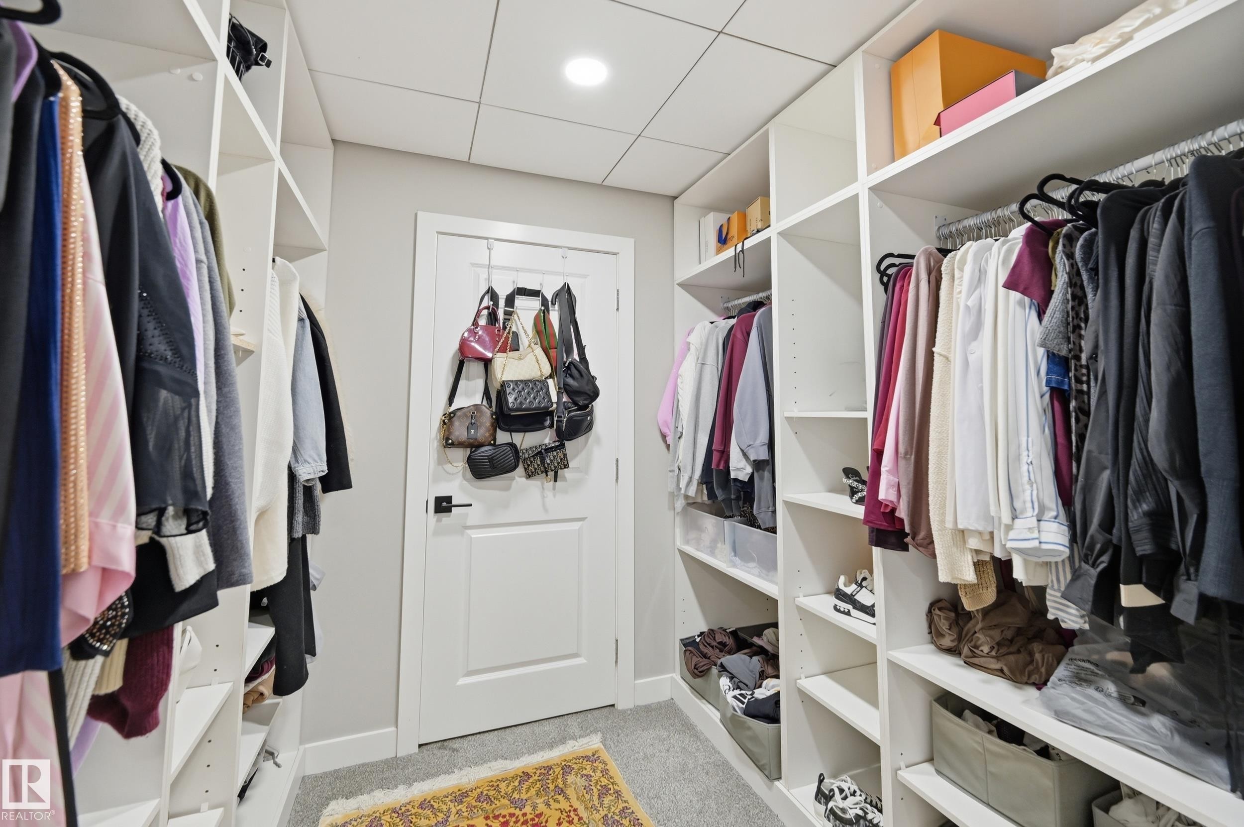 Integrated closet system featuring extensive shelving and hanging rods - 76 Jacobs Close, St. Albert, AB
