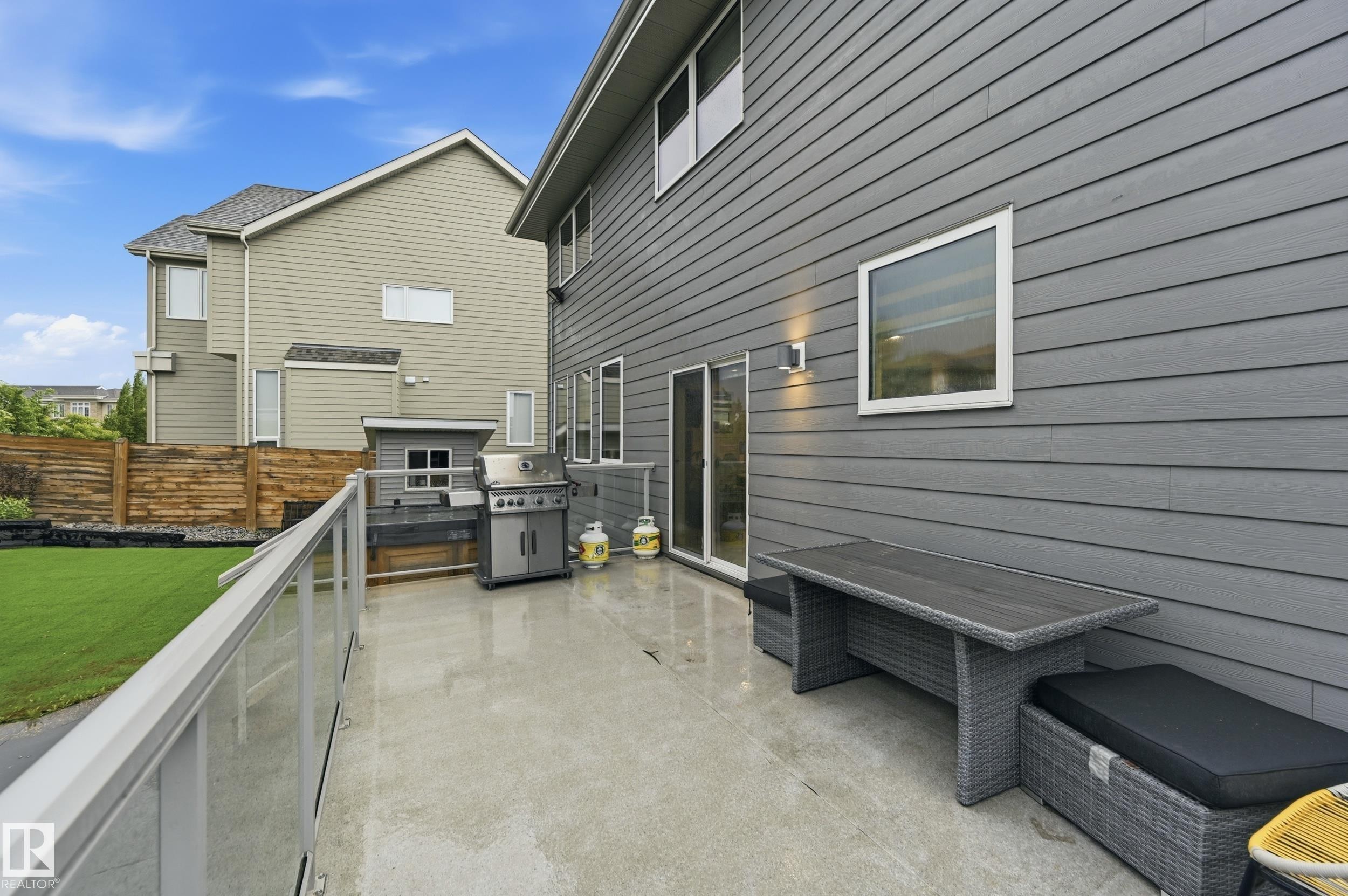 Concrete patio featuring a glass-paneled railing - 76 Jacobs Close, St. Albert, AB