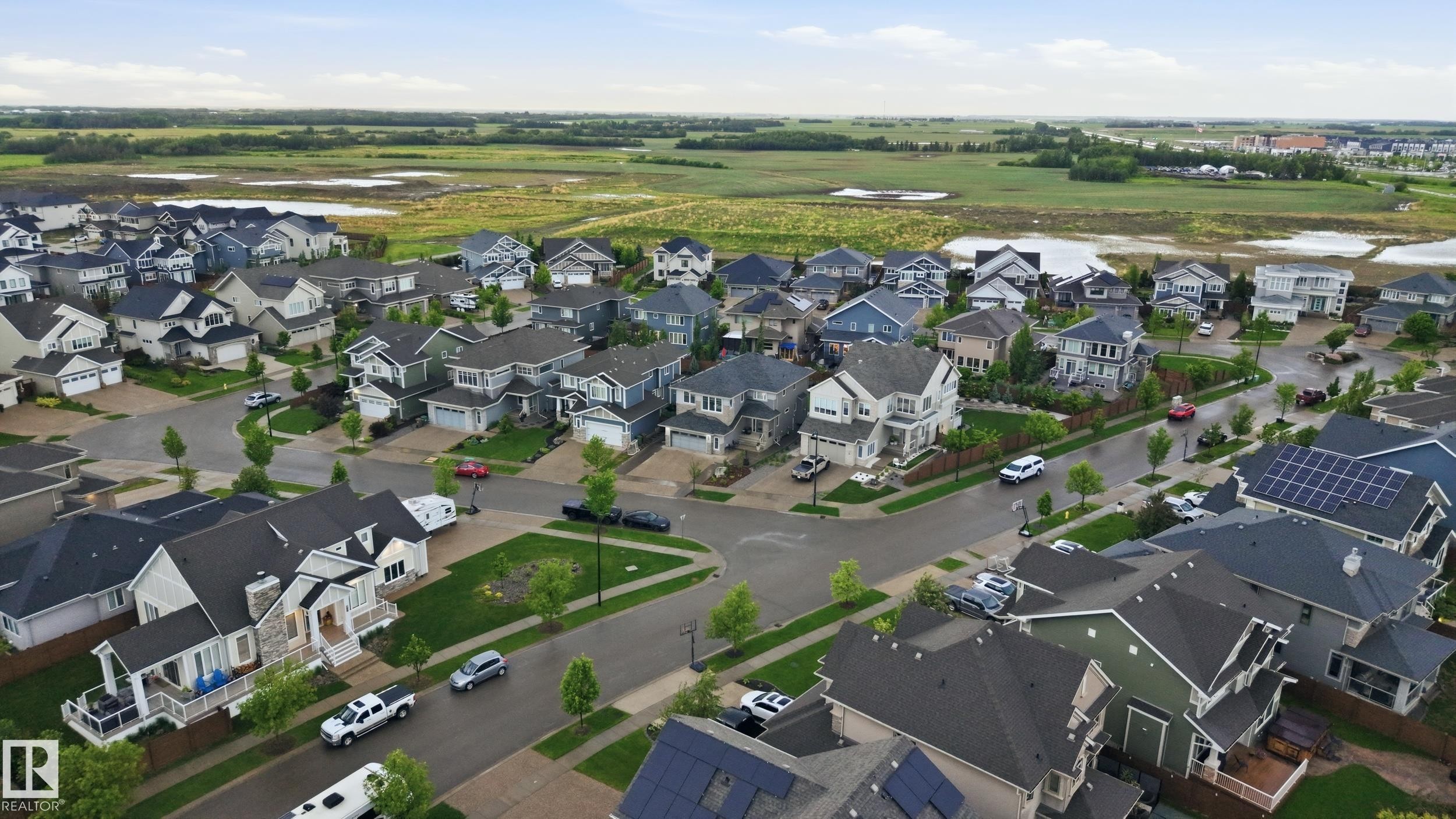 Aerial perspective showcasing a residential neighborhood with diverse architectural styles - 76 Jacobs Close, St. Albert, AB