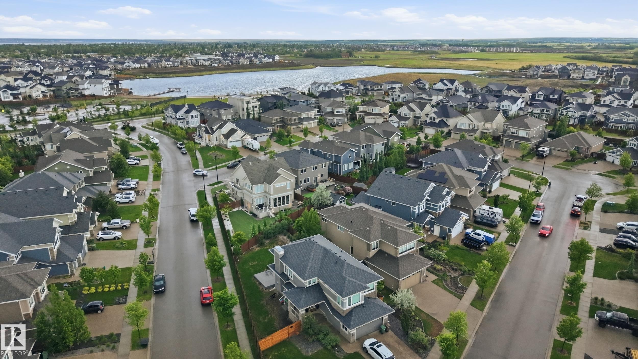 Aerial perspective of a developed residential area with a prominent body of water - 76 Jacobs Close, St. Albert, AB